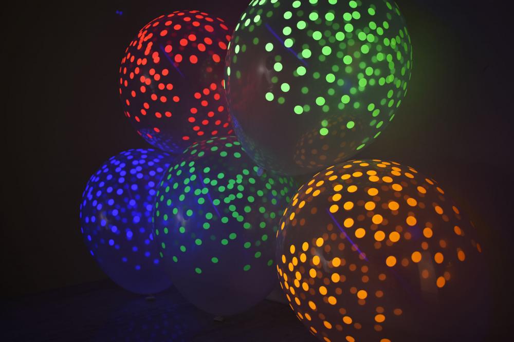glow in the dark balloons with neon confetti